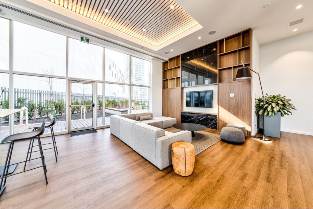 Fully furnished apartment in Vancouver for remote workers featuring an open-plan living space, dedicated workspace, and floor-to-ceiling windows overlooking Downtown Vancouver