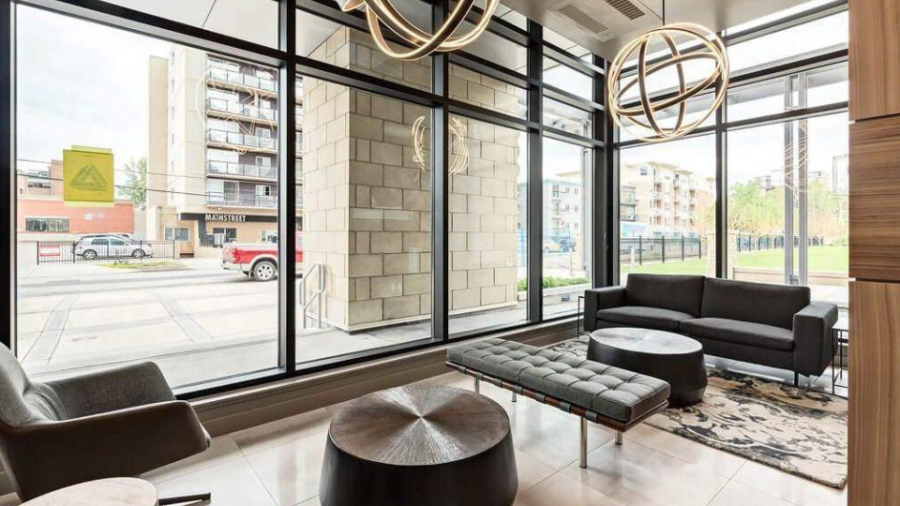 Corporate housing for business travel — furnished apartment living space with city skyline view