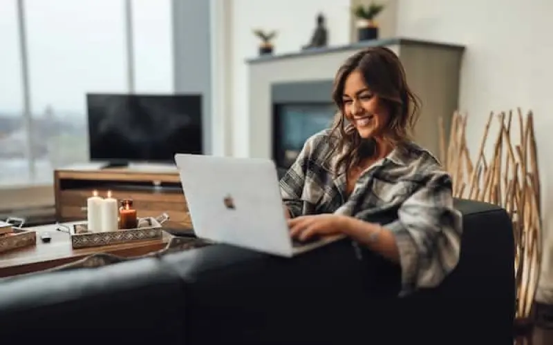 unmatched support from corporate housing team with a satisfied client in front of her laptop 952475a7