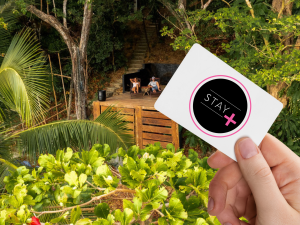 stay plus program by corporate stays - a photo showing a woman holding a card with the logo of the stay plus program and two people relaxing on a terrace in saboga lodge